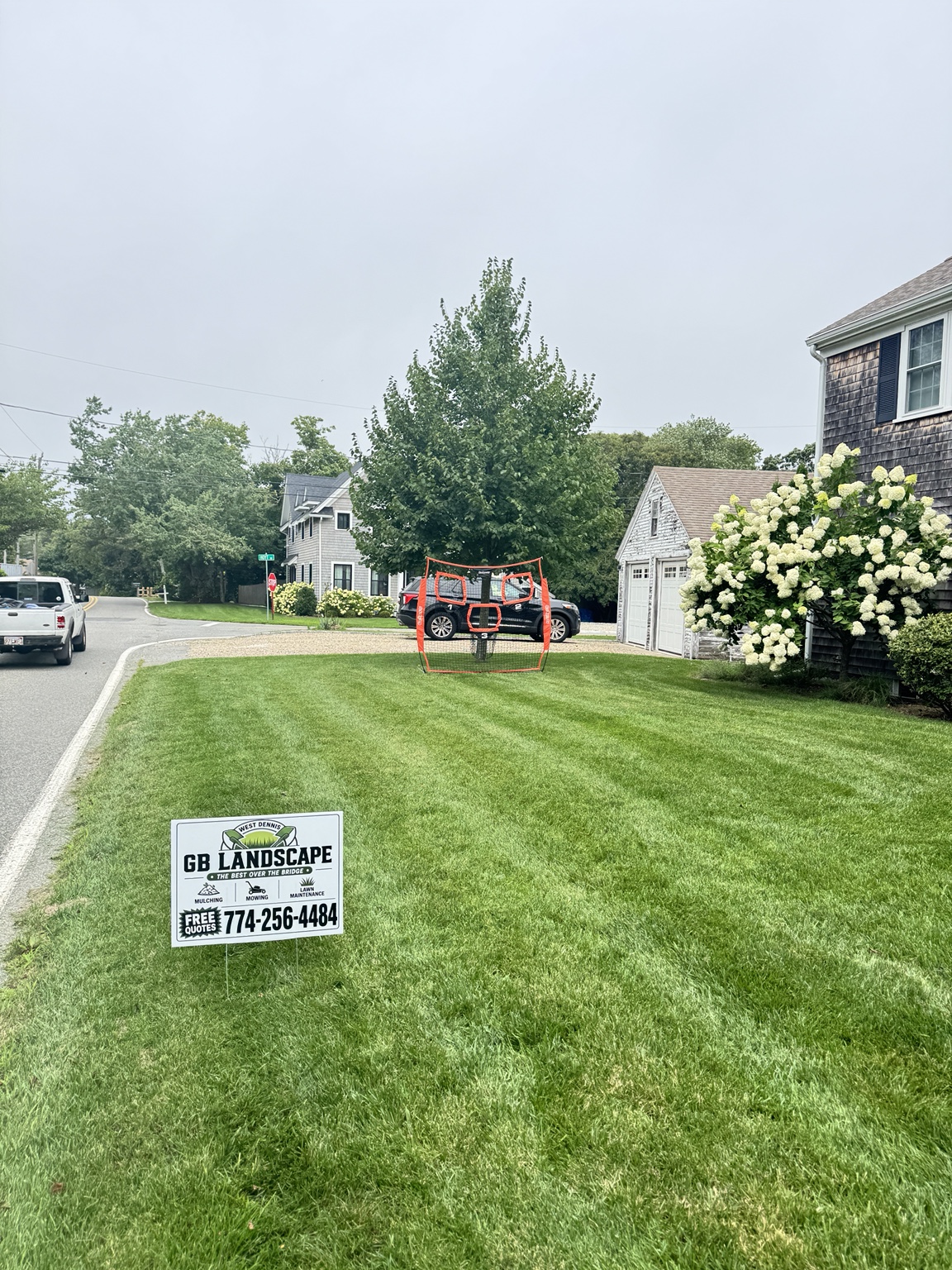 Freshly mowed lawn with a GB Landscape yard sign