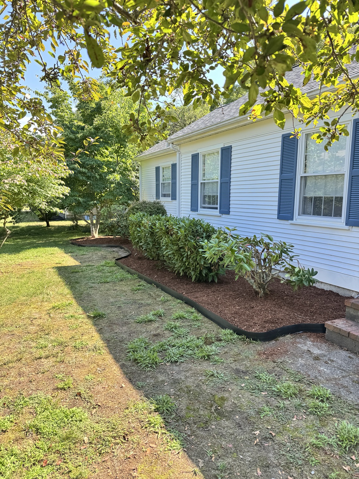 Fresh mulch bed along a home